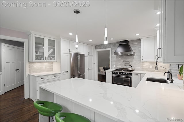 2640 Water Oaks Dr, West Bloomfield, MI 48324 - kitchen with ventilation hood, high end appliances, a peninsula, decorative backsplash, and glass insert cabinets