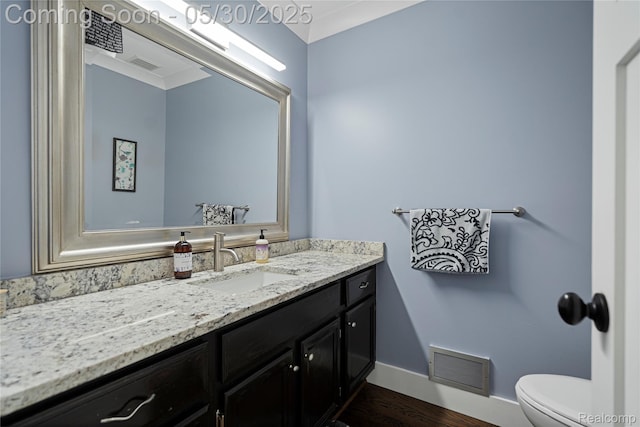 2640 Water Oaks Dr, West Bloomfield, MI 48324 - half bath featuring toilet, vanity, baseboards, and wood finished floors