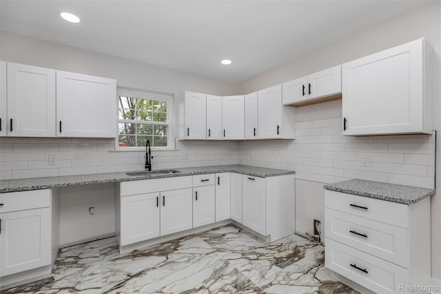 6080 Beniteau St, Detroit, MI 48213 - kitchen featuring a sink, light stone counters, light marble finish flooring, backsplash, and recessed lighting