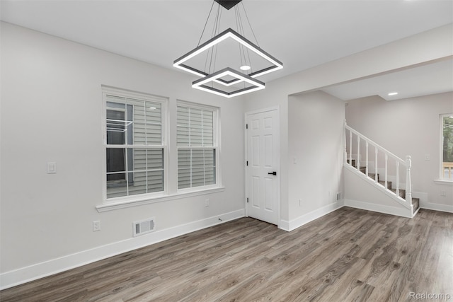 6080 Beniteau St, Detroit, MI 48213 - unfurnished dining area with stairs, wood finished floors, a chandelier, baseboards, and recessed lighting