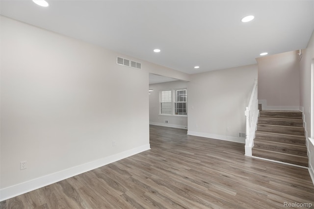 6080 Beniteau St, Detroit, MI 48213 - unfurnished living room with stairs, baseboards, wood finished floors, and recessed lighting