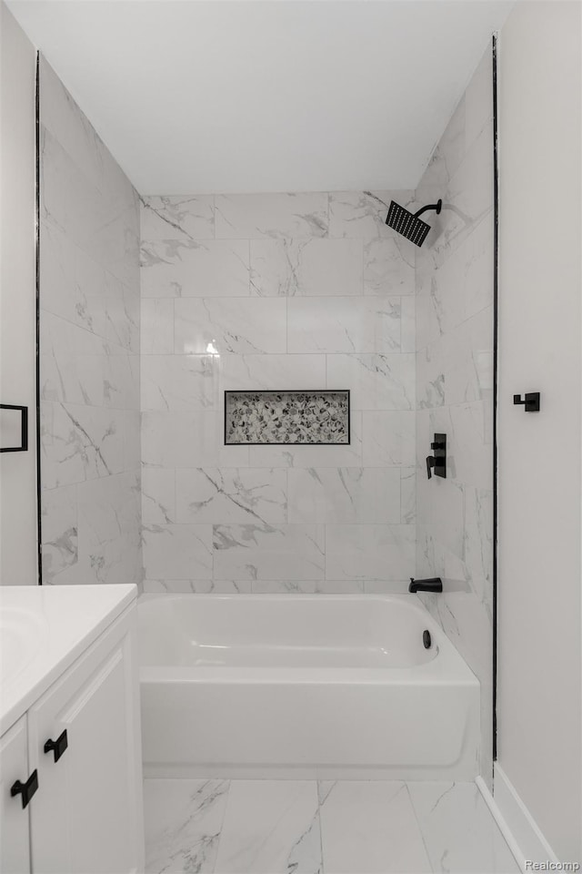 6080 Beniteau St, Detroit, MI 48213 - bathroom featuring marble look tiles, washtub / shower combination, vanity, and baseboards