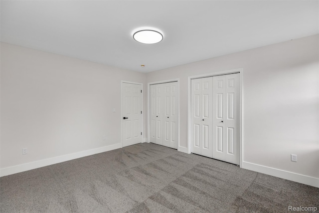 6080 Beniteau St, Detroit, MI 48213 - unfurnished bedroom featuring multiple closets, baseboards, and carpet