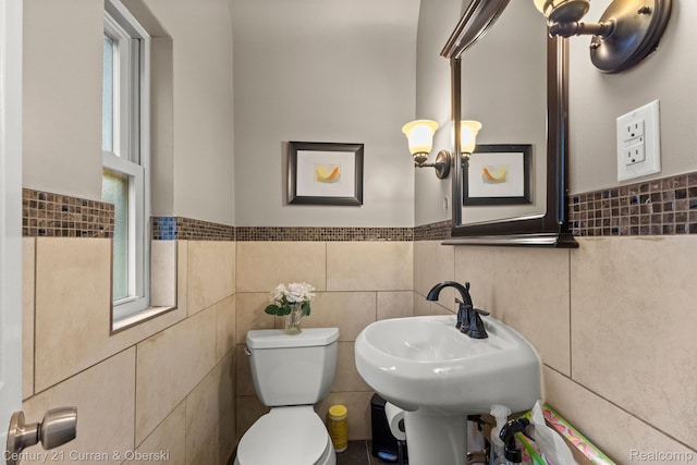21975 Wildwood St, Dearborn, MI 48128 - half bathroom with tile walls, toilet, and a wainscoted wall