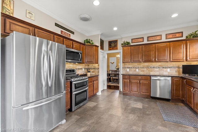 21975 Wildwood St, Dearborn, MI 48128 - kitchen with stainless steel appliances, backsplash, ornamental molding, brown cabinetry, and dark stone countertops