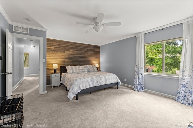 21975 Wildwood St, Dearborn, MI 48128 - carpeted bedroom with wooden walls, crown molding, baseboards, an accent wall, and ceiling fan
