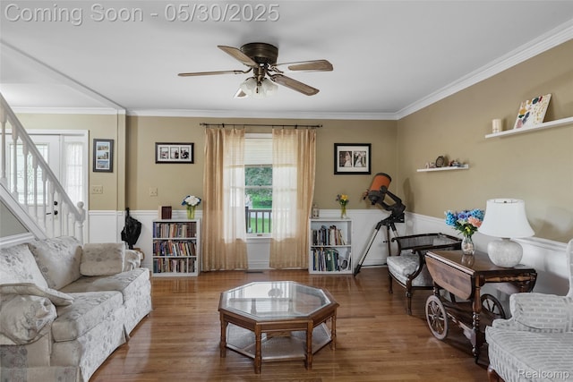 61472 Tayberry Cir S, Lyon, MI 48178 - living area featuring a ceiling fan, crown molding, wood finished floors, stairs, and a wainscoted wall