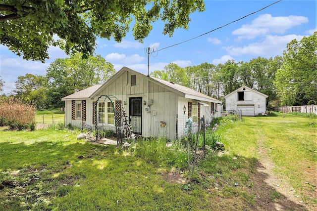 33891 Bertrand St, Niles, MI 49120 - view of front facade featuring board and batten siding and a detached garage