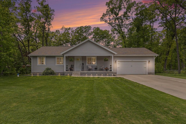 631 N Hilton Park Rd, Muskegon, MI 49442 - view of front facade featuring a porch, concrete driveway, a garage, and a front lawn