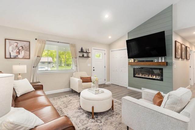 631 N Hilton Park Rd, Muskegon, MI 49442 - living room with wood finished floors, a large fireplace, vaulted ceiling, recessed lighting, and baseboards