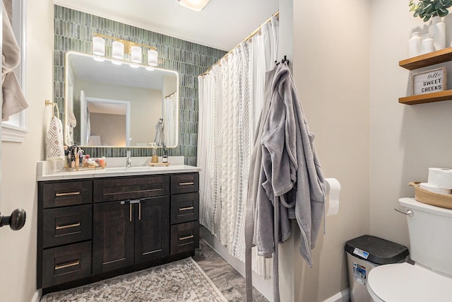 631 N Hilton Park Rd, Muskegon, MI 49442 - bathroom with toilet, vanity, marble look tiles, and baseboards