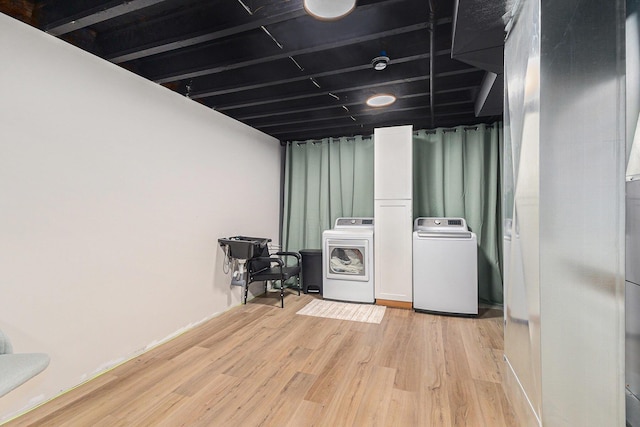 631 N Hilton Park Rd, Muskegon, MI 49442 - laundry area featuring washer and clothes dryer and light wood-style flooring