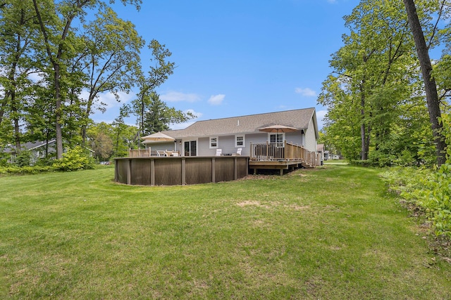631 N Hilton Park Rd, Muskegon, MI 49442 - rear view of property featuring a deck, a swimming pool, and a yard
