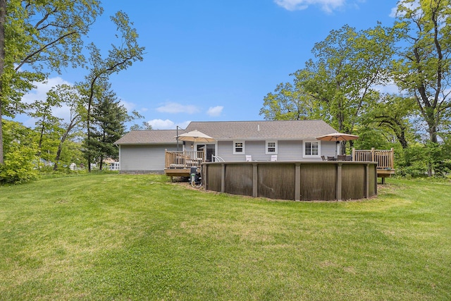 631 N Hilton Park Rd, Muskegon, MI 49442 - back of property with a deck, an outdoor pool, and a yard