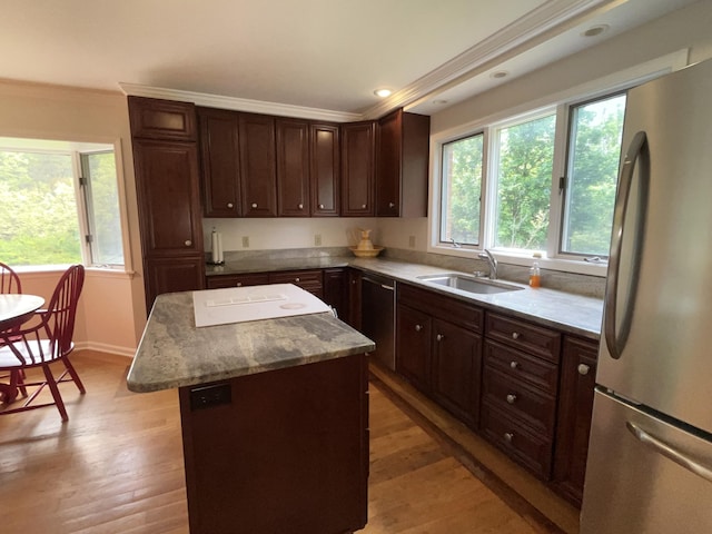 1749 42nd St, Allegan, MI 49010 - kitchen with appliances with stainless steel finishes, a sink, crown molding, a kitchen island, and healthy amount of natural light