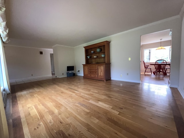 1749 42nd St, Allegan, MI 49010 - unfurnished living room with light wood-style flooring, crown molding, and baseboards