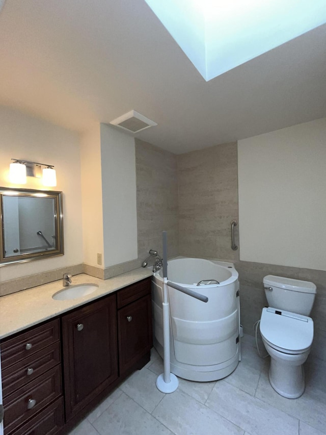 1749 42nd St, Allegan, MI 49010 - bathroom with vanity, a bath, tile patterned flooring, and toilet
