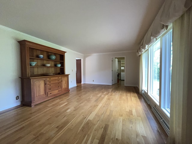 1749 42nd St, Allegan, MI 49010 - unfurnished living room with light wood finished floors, ornamental molding, and baseboards