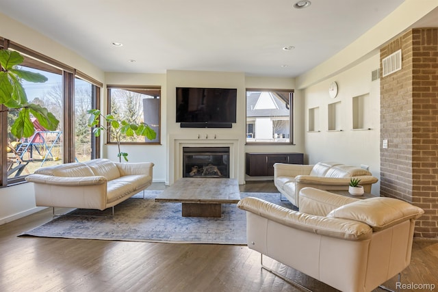 1000 Forest Ln, Bloomfield Hills, MI 48301 - living area with wood finished floors, a glass covered fireplace, recessed lighting, and baseboards