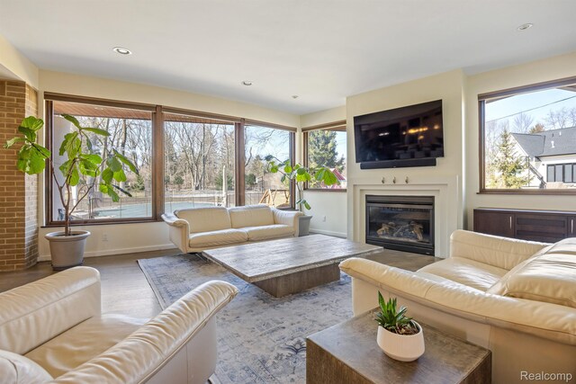1000 Forest Ln, Bloomfield Hills, MI 48301 - living room featuring plenty of natural light, a glass covered fireplace, baseboards, wood finished floors, and recessed lighting