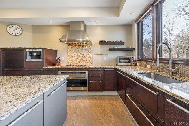 1000 Forest Ln, Bloomfield Hills, MI 48301 - kitchen featuring oven, wall chimney range hood, a sink, light wood finished floors, and recessed lighting