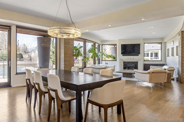 1000 Forest Ln, Bloomfield Hills, MI 48301 - dining room with wood finished floors, a glass covered fireplace, recessed lighting, a chandelier, and baseboards