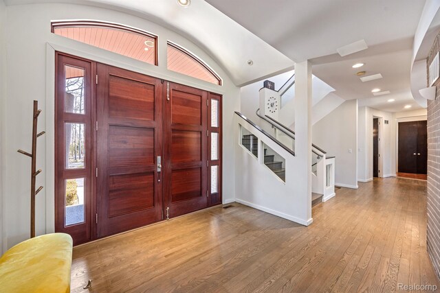 1000 Forest Ln, Bloomfield Hills, MI 48301 - foyer entrance with stairway, baseboards, wood finished floors, healthy amount of natural light, and vaulted ceiling