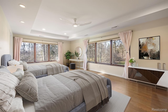 1000 Forest Ln, Bloomfield Hills, MI 48301 - bedroom featuring a tray ceiling, wood finished floors, multiple windows, recessed lighting, and ceiling fan