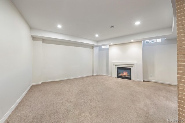 1000 Forest Ln, Bloomfield Hills, MI 48301 - finished below grade area featuring a glass covered fireplace, recessed lighting, carpet, and baseboards