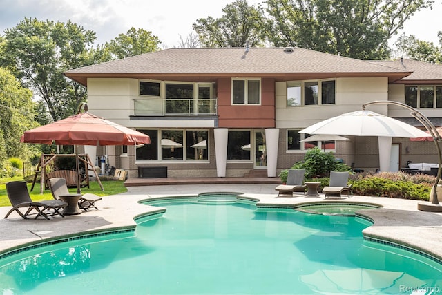 1000 Forest Ln, Bloomfield Hills, MI 48301 - rear view of property with a patio, a balcony, a shingled roof, and a pool with connected hot tub