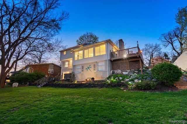1425 Shankin Dr, Wolverine Lake, MI 48390 - rear view of property with a chimney, a lawn, a wooden deck, and stairway