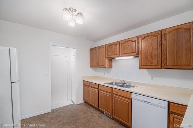164 Barrington Cir, Lake Orion, MI 48360 - kitchen featuring white appliances, a sink, brown cabinetry, and light countertops