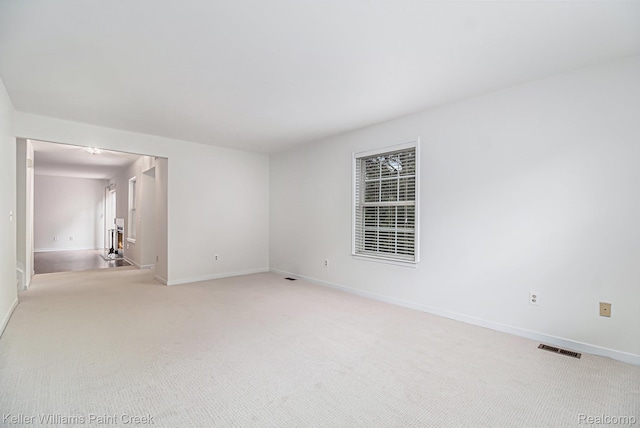 164 Barrington Cir, Lake Orion, MI 48360 - spare room featuring light carpet and baseboards