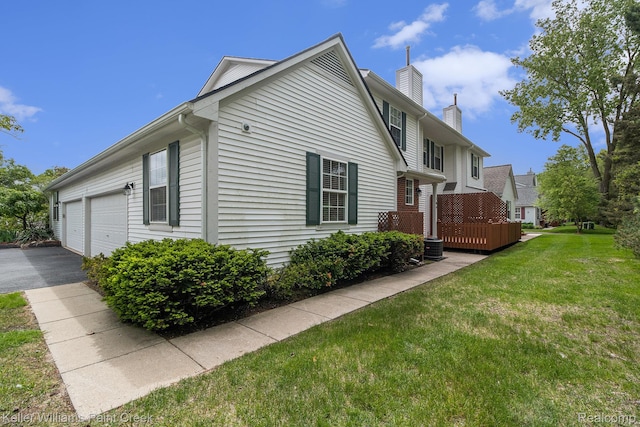 164 Barrington Cir, Lake Orion, MI 48360 - view of side of home with a chimney, a lawn, and driveway