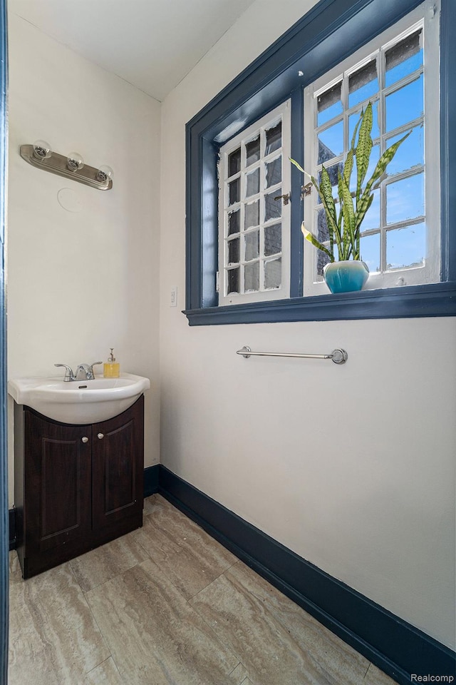 8123 E Lafayette St, Detroit, MI 48214 - bathroom with vanity, wood finished floors, and baseboards