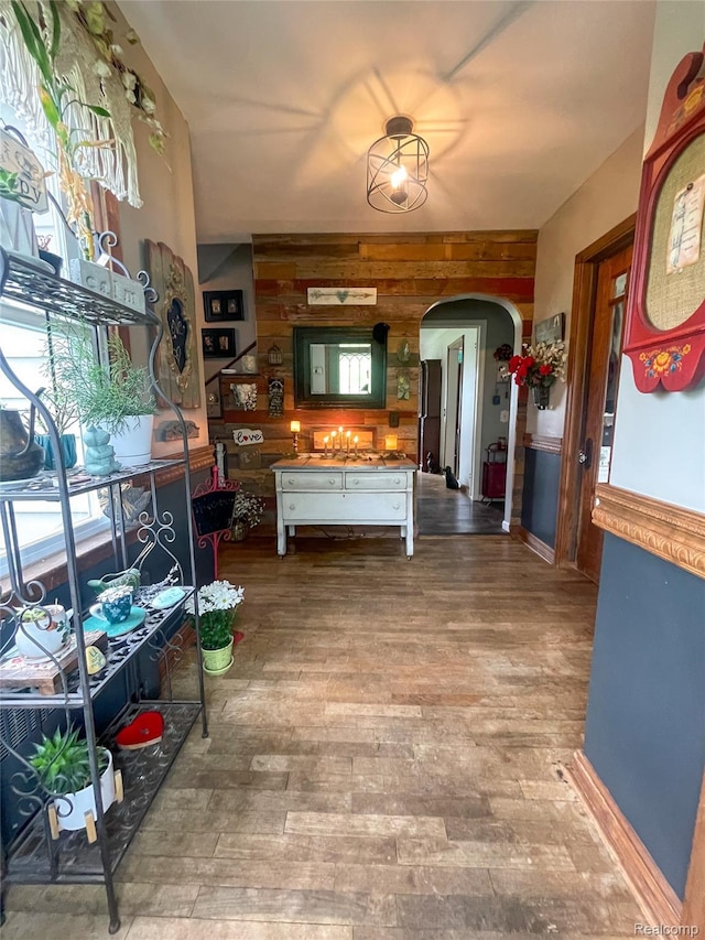 1264 Brabbs St, Burton, MI 48509 - kitchen with arched walkways, wood walls, and wood finished floors