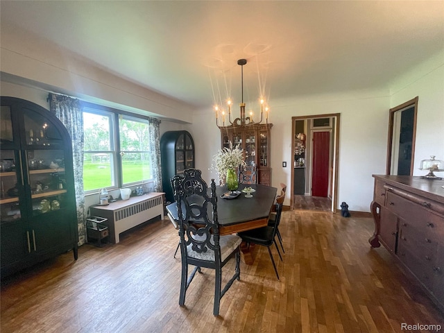 1264 Brabbs St, Burton, MI 48509 - dining room featuring a chandelier, radiator heating unit, and dark wood-style flooring