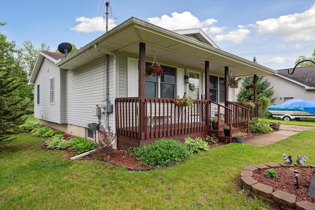 113 Diversy Dr, Brooklyn, MI 49230 - view of front of home featuring covered porch and a front yard
