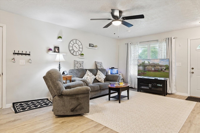 113 Diversy Dr, Brooklyn, MI 49230 - living room featuring wood finished floors, a ceiling fan, a textured ceiling, and baseboards