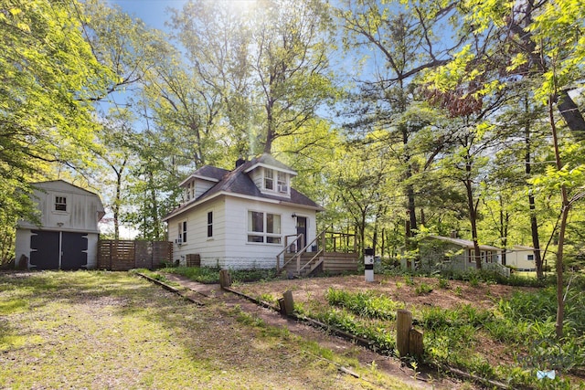18335 Oakland Dr, New Buffalo, MI 49117 - back of property with stairs, a wooden deck, and an outbuilding