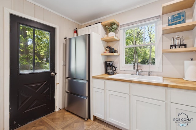 18335 Oakland Dr, New Buffalo, MI 49117 - kitchen featuring open shelves, ornamental molding, a sink, wood counters, and freestanding refrigerator