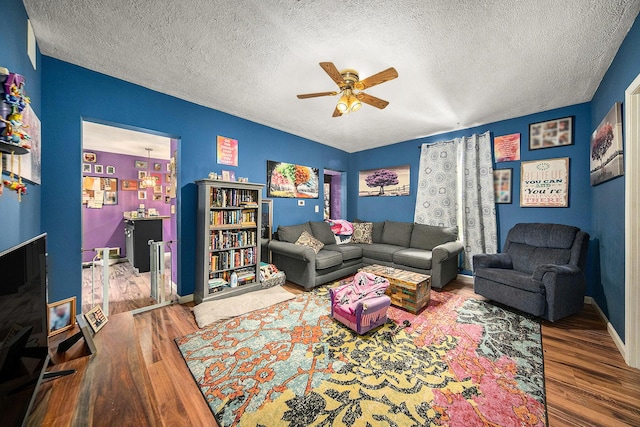 114 Orange St, Jackson, MI 49202 - living room featuring wood finished floors, ceiling fan, a textured ceiling, and baseboards