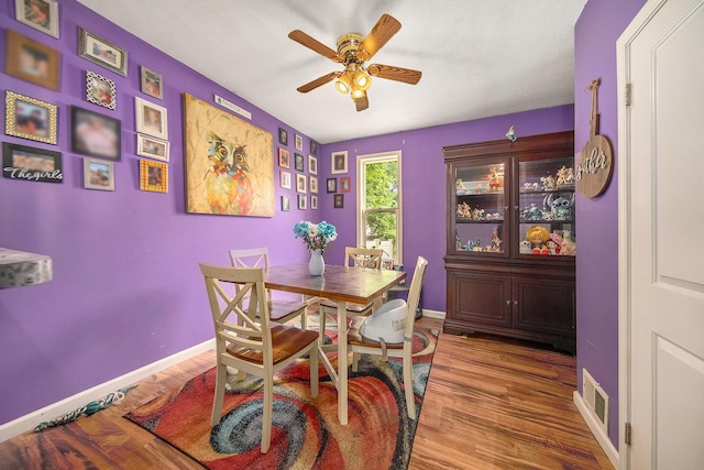 114 Orange St, Jackson, MI 49202 - dining room featuring ceiling fan, wood finished floors, and baseboards