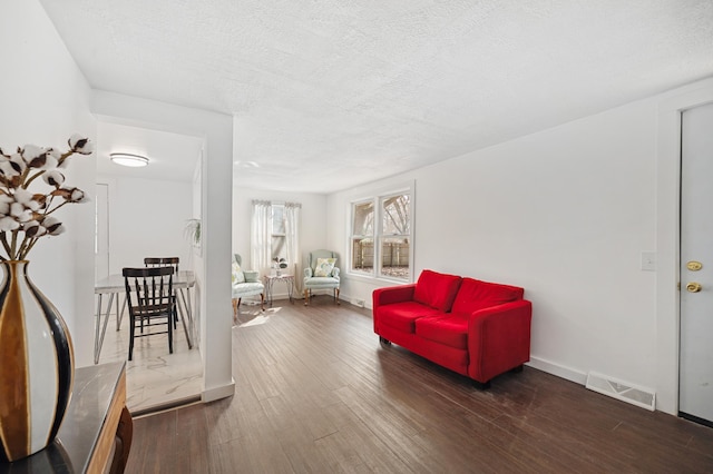 1585 Leeds Ave, Benton Harbor, MI 49022 - living area with wood finished floors, a textured ceiling, and baseboards