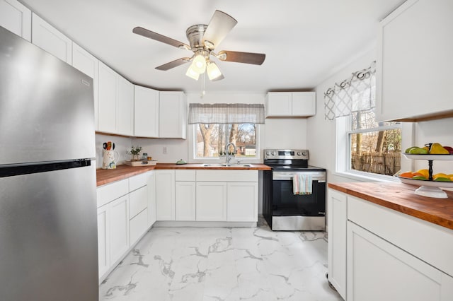 1585 Leeds Ave, Benton Harbor, MI 49022 - kitchen featuring stainless steel appliances, butcher block counters, a sink, and white cabinetry