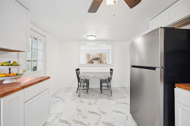 1585 Leeds Ave, Benton Harbor, MI 49022 - dining room with marble finish flooring, a ceiling fan, and baseboards