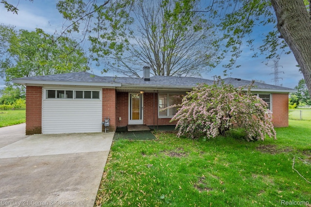2548 Hearthside Dr, Ypsilanti, MI 48198 - ranch-style house with brick siding, concrete driveway, a front lawn, an attached garage, and a chimney