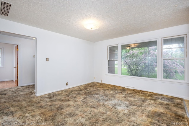 2548 Hearthside Dr, Ypsilanti, MI 48198 - empty room featuring carpet floors, a textured ceiling, and baseboards