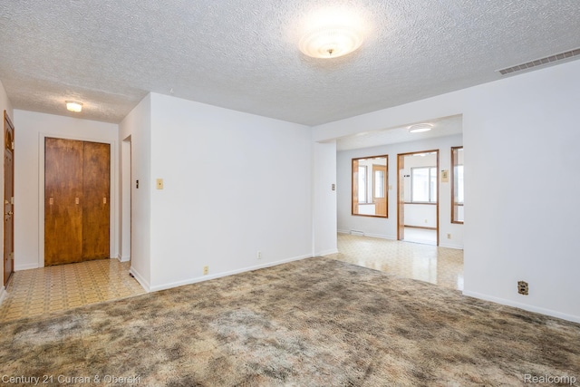 2548 Hearthside Dr, Ypsilanti, MI 48198 - carpeted empty room featuring a textured ceiling and baseboards