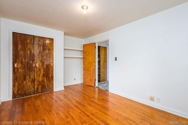 2548 Hearthside Dr, Ypsilanti, MI 48198 - unfurnished bedroom featuring a closet, wood finished floors, and baseboards